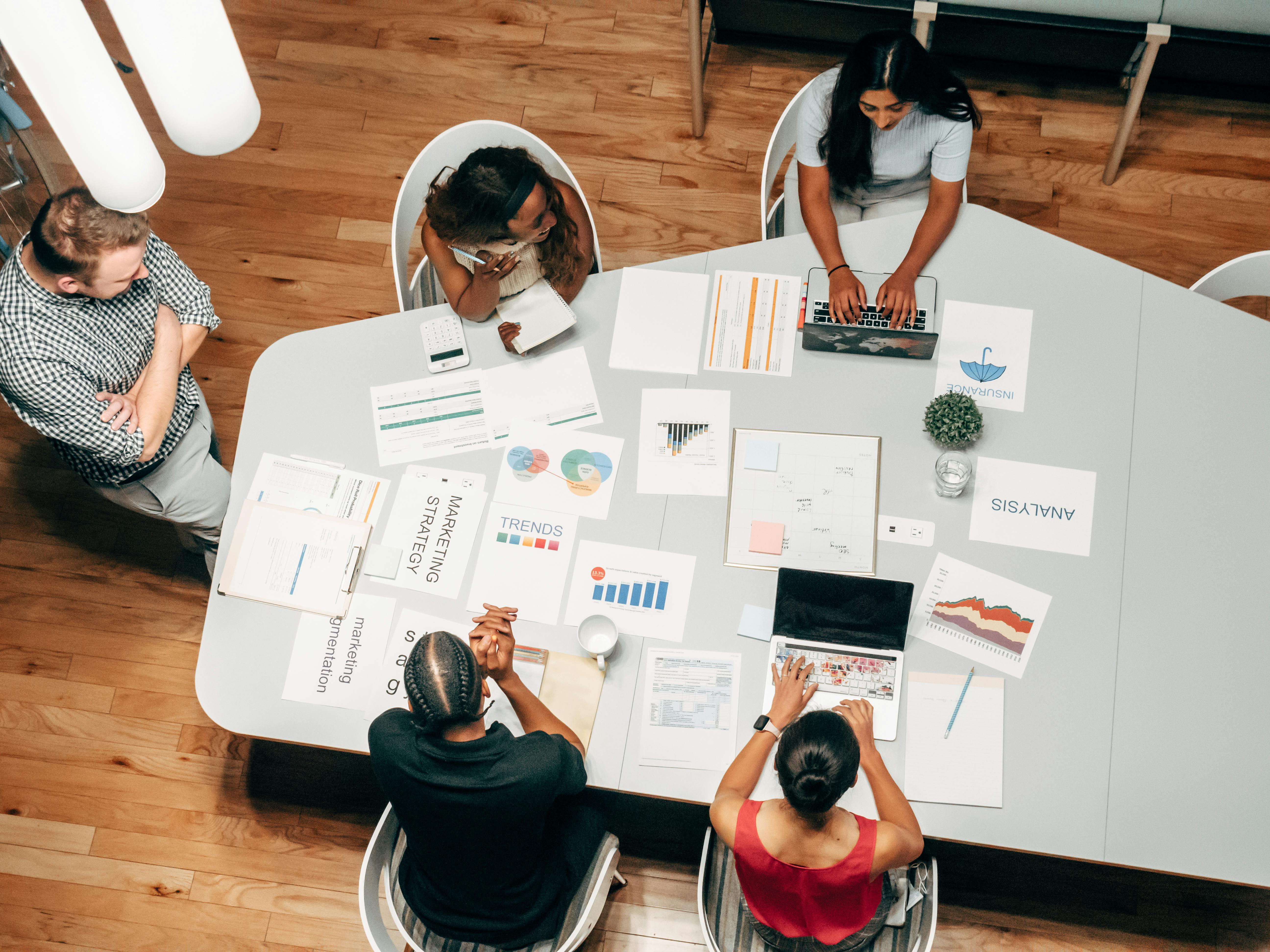 A team working collaboratively around a large screen in a bright, open office